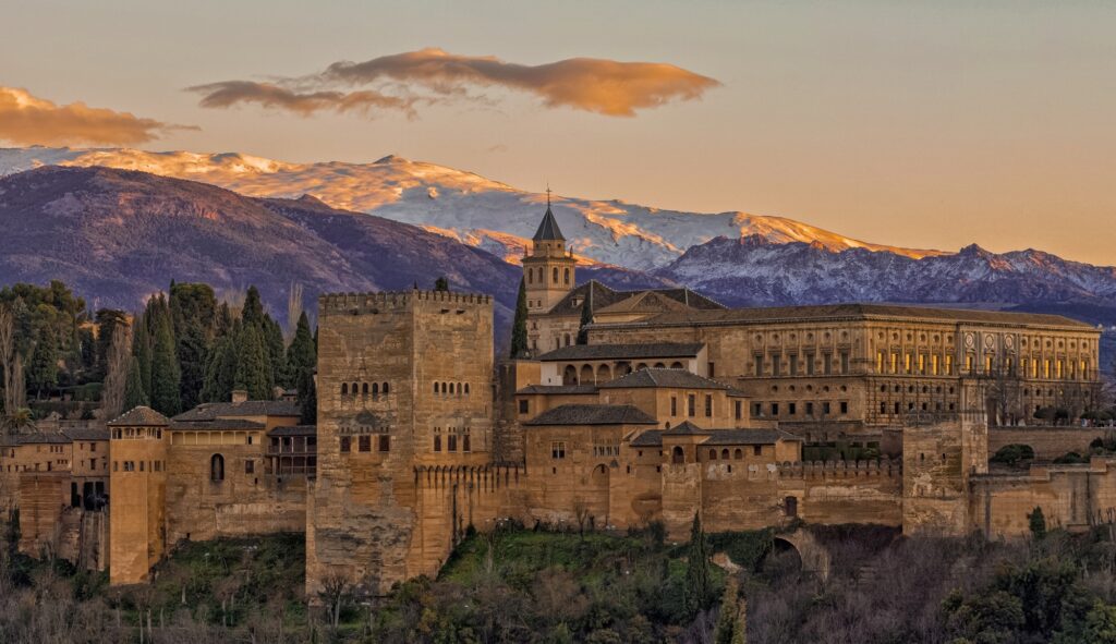 View of Alhambra Palace from San Nicolas viewpoint at sunset (Granada, Spain), most iconic landmarks in the world