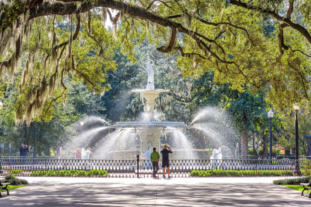 Couple at Forsyth Park in Savannah Georgia, which is known as one of the best vacation spots for couples in the U.S. 