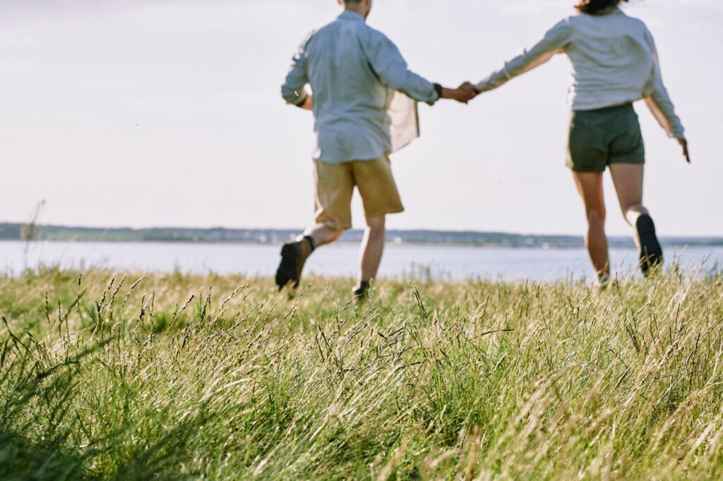 Couple running at Martha's Vineyard, MA, which is one of the best vacation spots for couples in the U.S. 