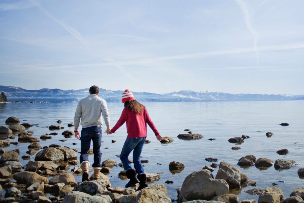 Couple walking on rocks in Lake Tahoe, CA