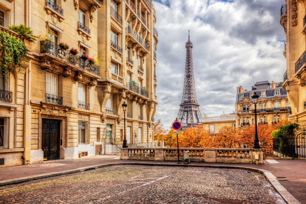 Paris, France street and building, with the Eiffel Tower in the background.